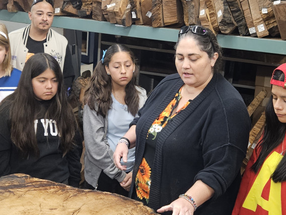 Assistant Curator Shannon Harrel in the archive with Hendricks students.